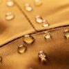 Close-up of water-resistant upholstery fabric with water droplets demonstrating moisture and stain resistance for coastal living