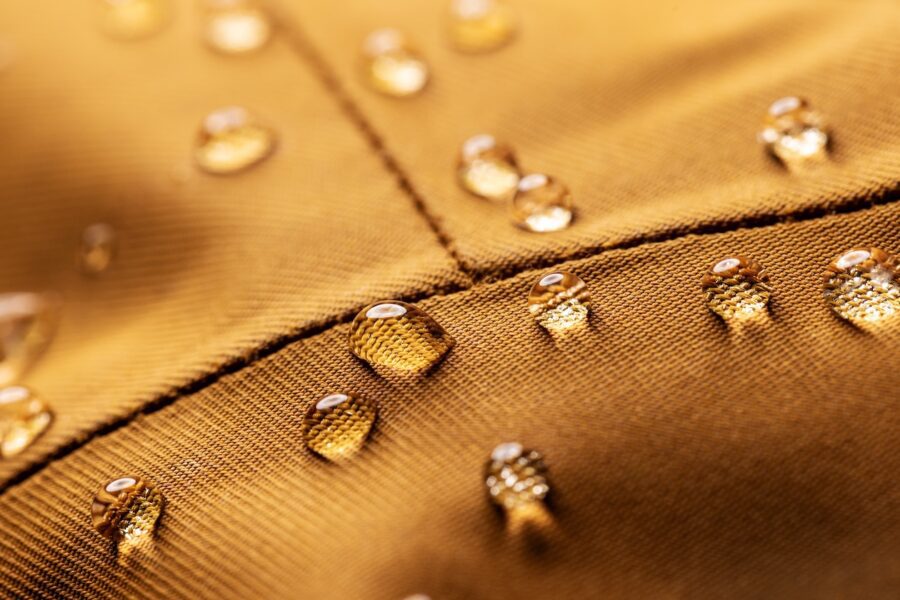 Close-up of water-resistant upholstery fabric with water droplets demonstrating moisture and stain resistance for coastal living