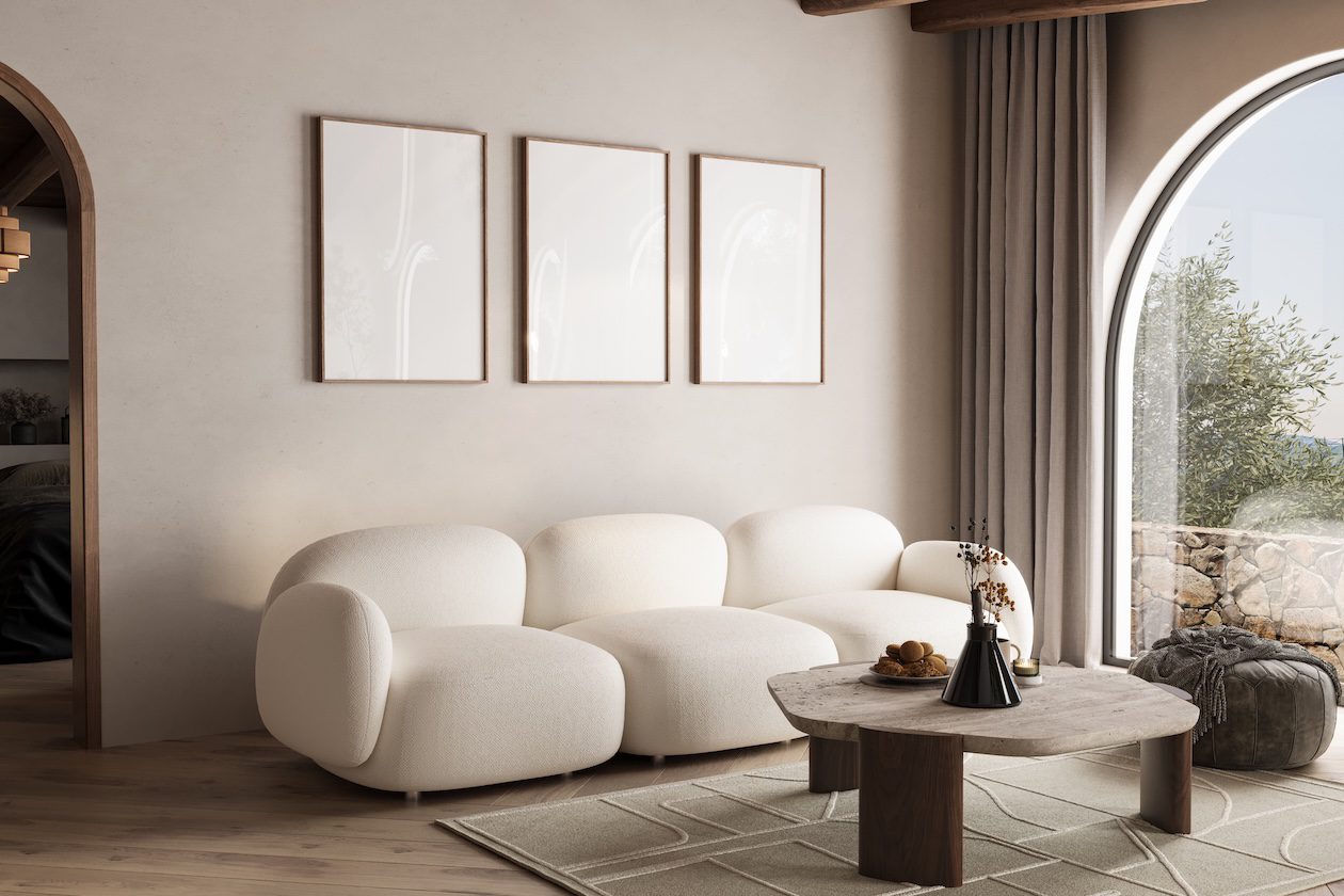 Scandinavian-inspired coastal living room with soft neutral tones, layered textures, modern curved seating, natural wood accents, and minimalist California casual styling in a bright, airy interior.