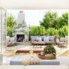 Open-concept California casual living room with large doors opening to an outdoor patio, featuring neutral furnishings, natural wood accents, and seamless indoor-outdoor living.