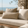 Sunlit coastal patio furniture on balcony