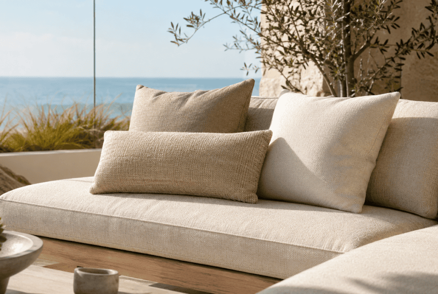 Sunlit coastal patio furniture on balcony