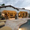 Luxury Southern California backyard with a covered patio, custom outdoor cushions, poolside lounge chairs, and seamless indoor-outdoor living.