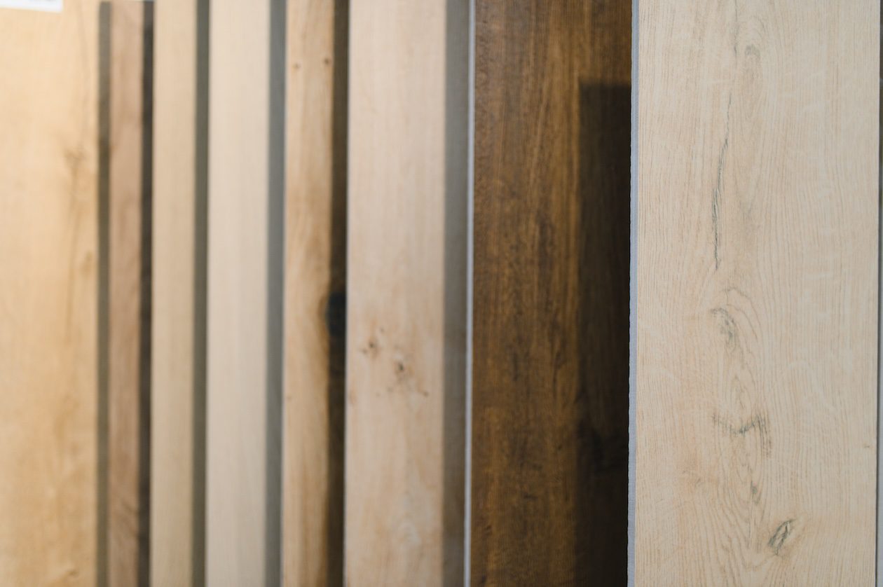 Wood flooring samples displaying a range of light and dark wood tones, grains, and textures.